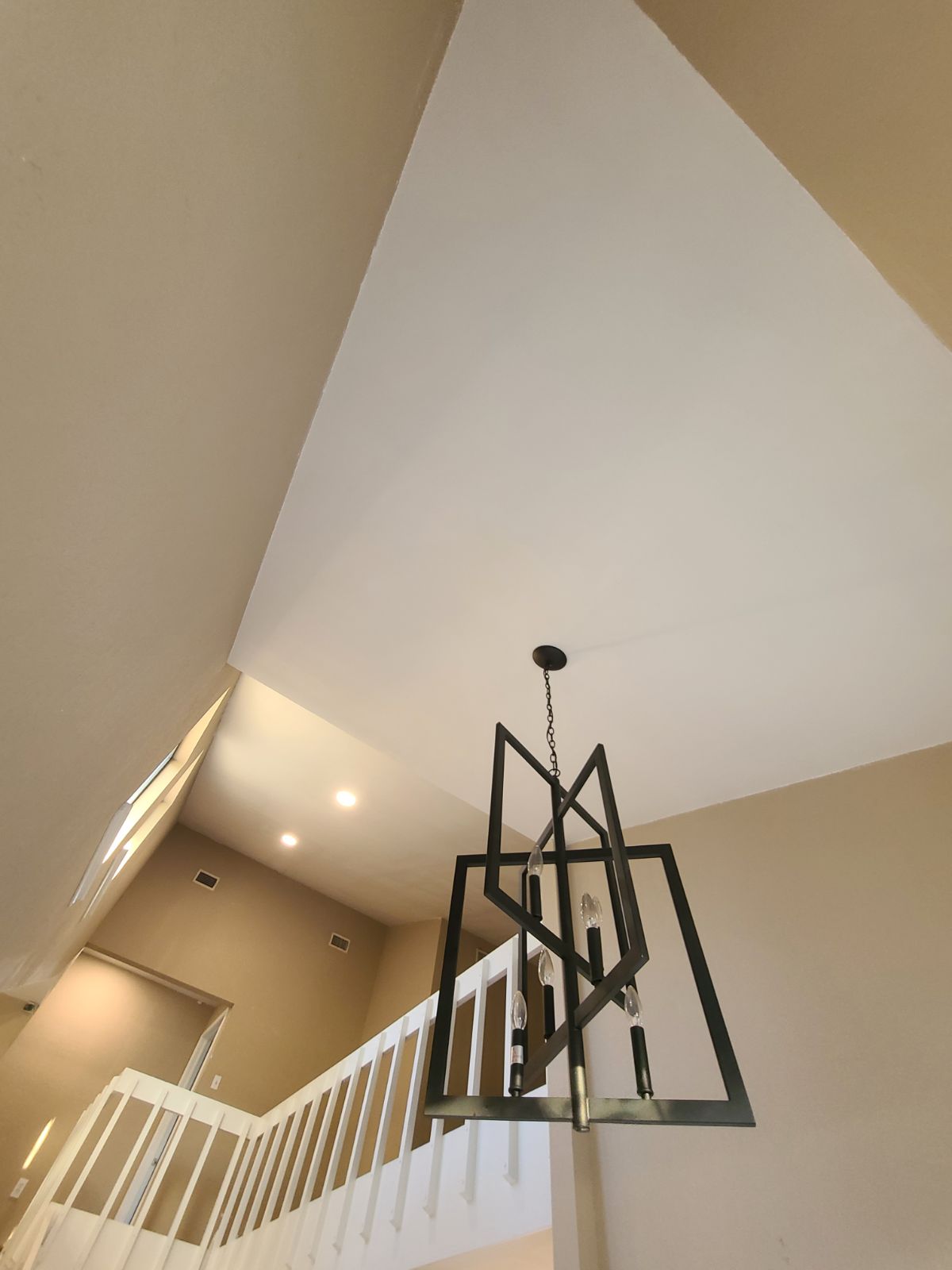 New Drywall and paint with custom light fixture. New home remodel and handrail on the stairway.