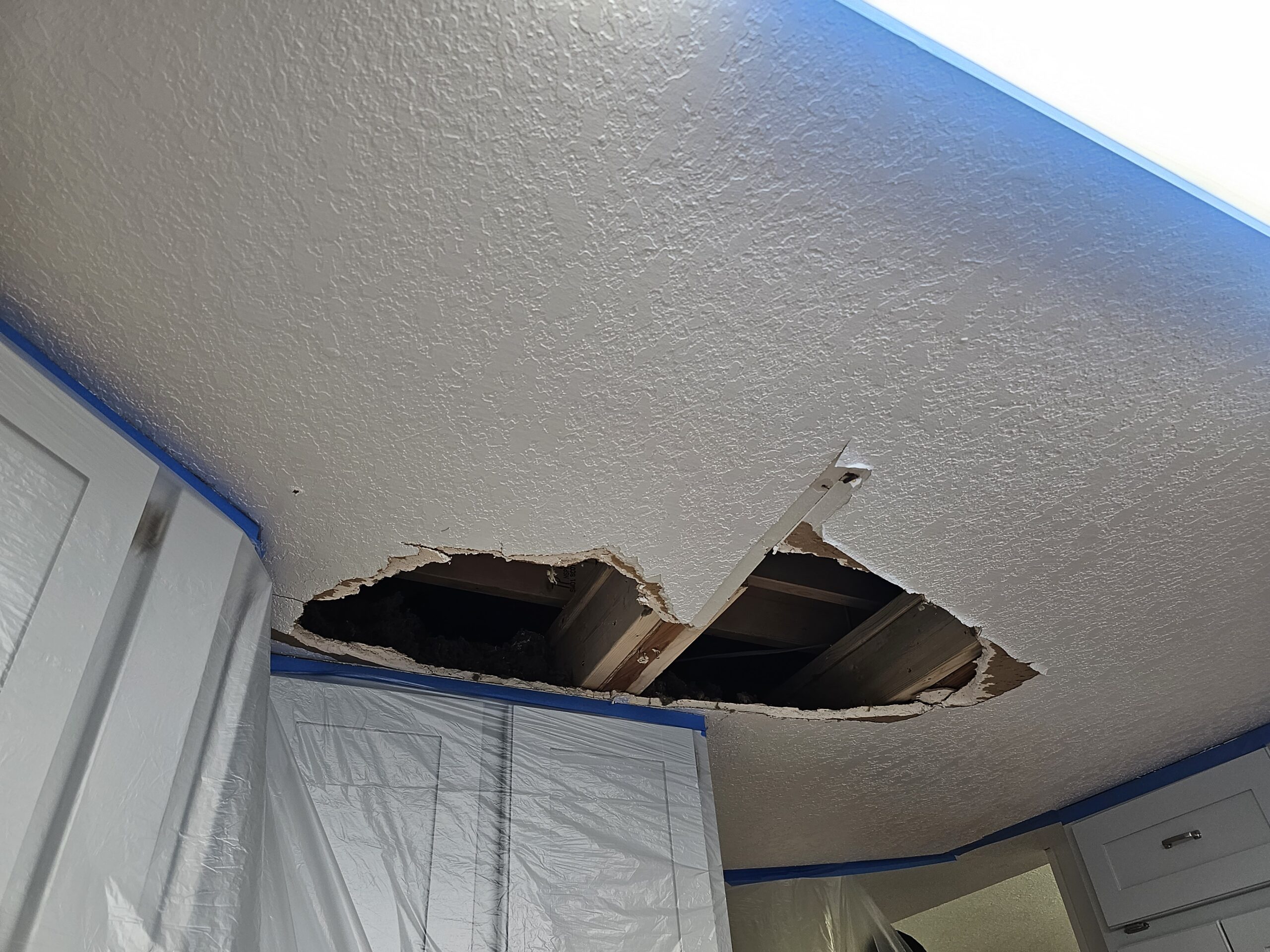 Before photo of damaged ceiling drywall needing repair