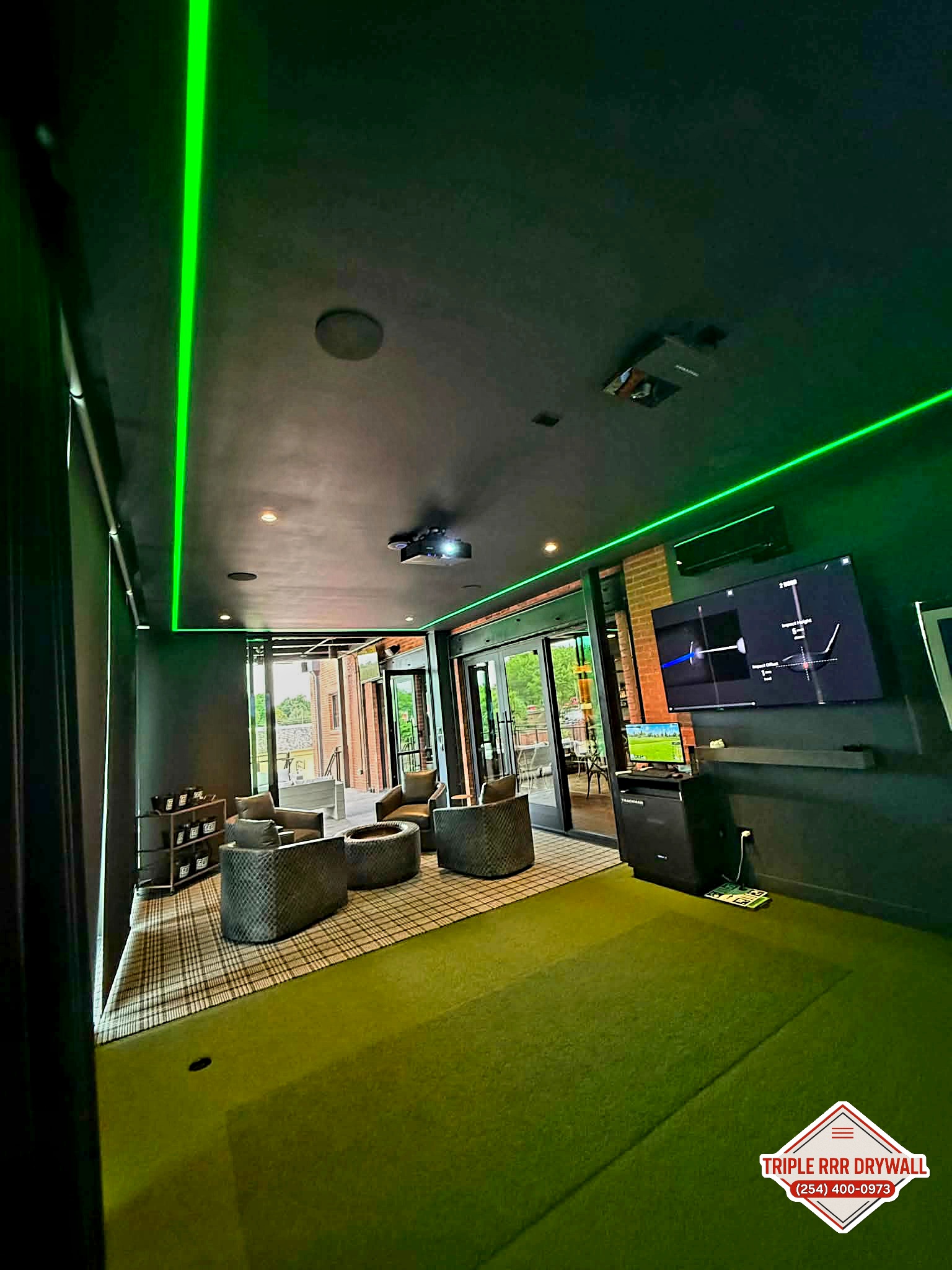 Completed Waco golf simulator room with Level 5 drywall finish and paint by Triple RRR Drywall