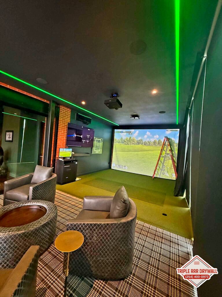Completed Waco golf simulator room with smooth dark walls and finished ceiling