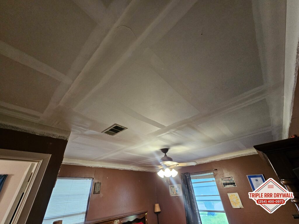 Sheetrock installation on a ceiling repair tape and float.