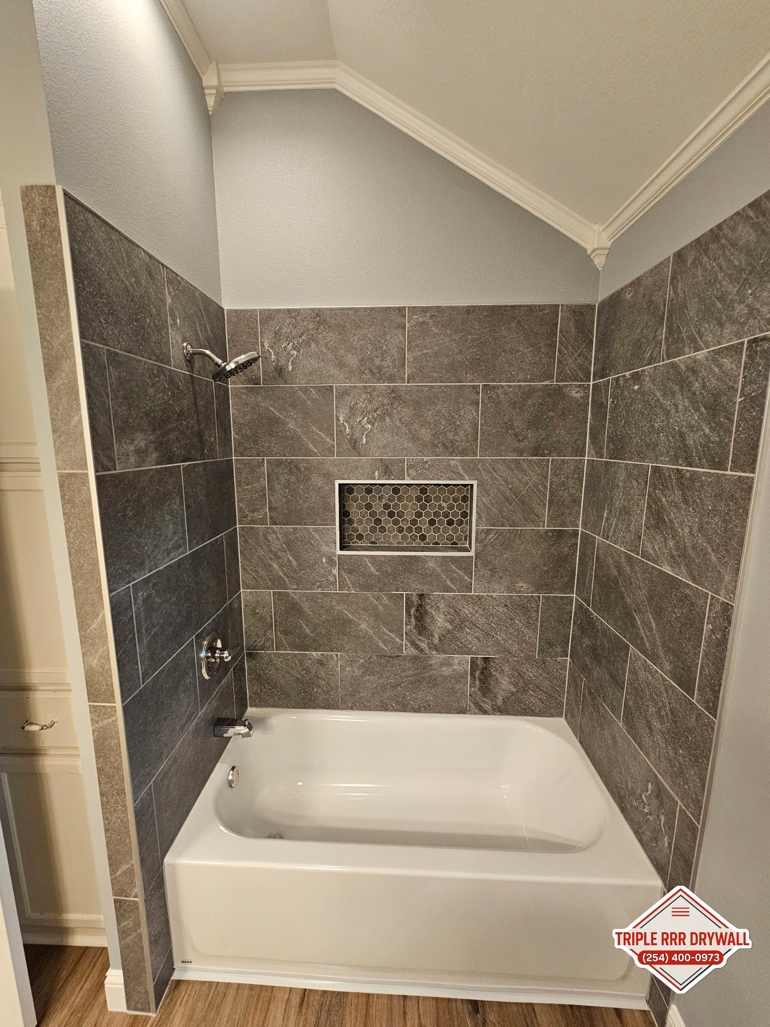 Finished Waco bathroom water leak repair with new tub tile walls flooring and paint by Triple RRR Drywall