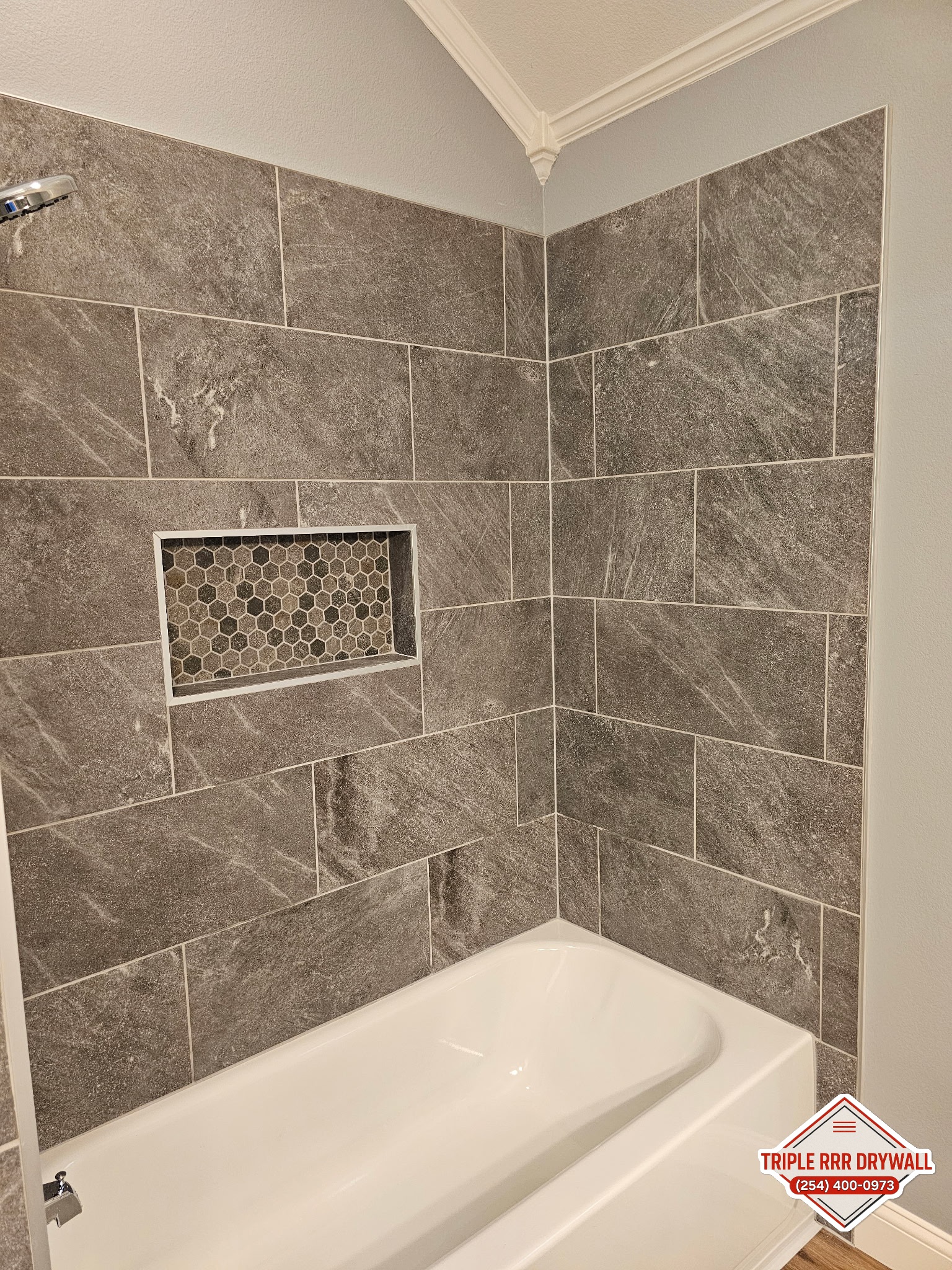 New tub and tile walls after Waco bathroom water damage repair by Triple RRR Drywall