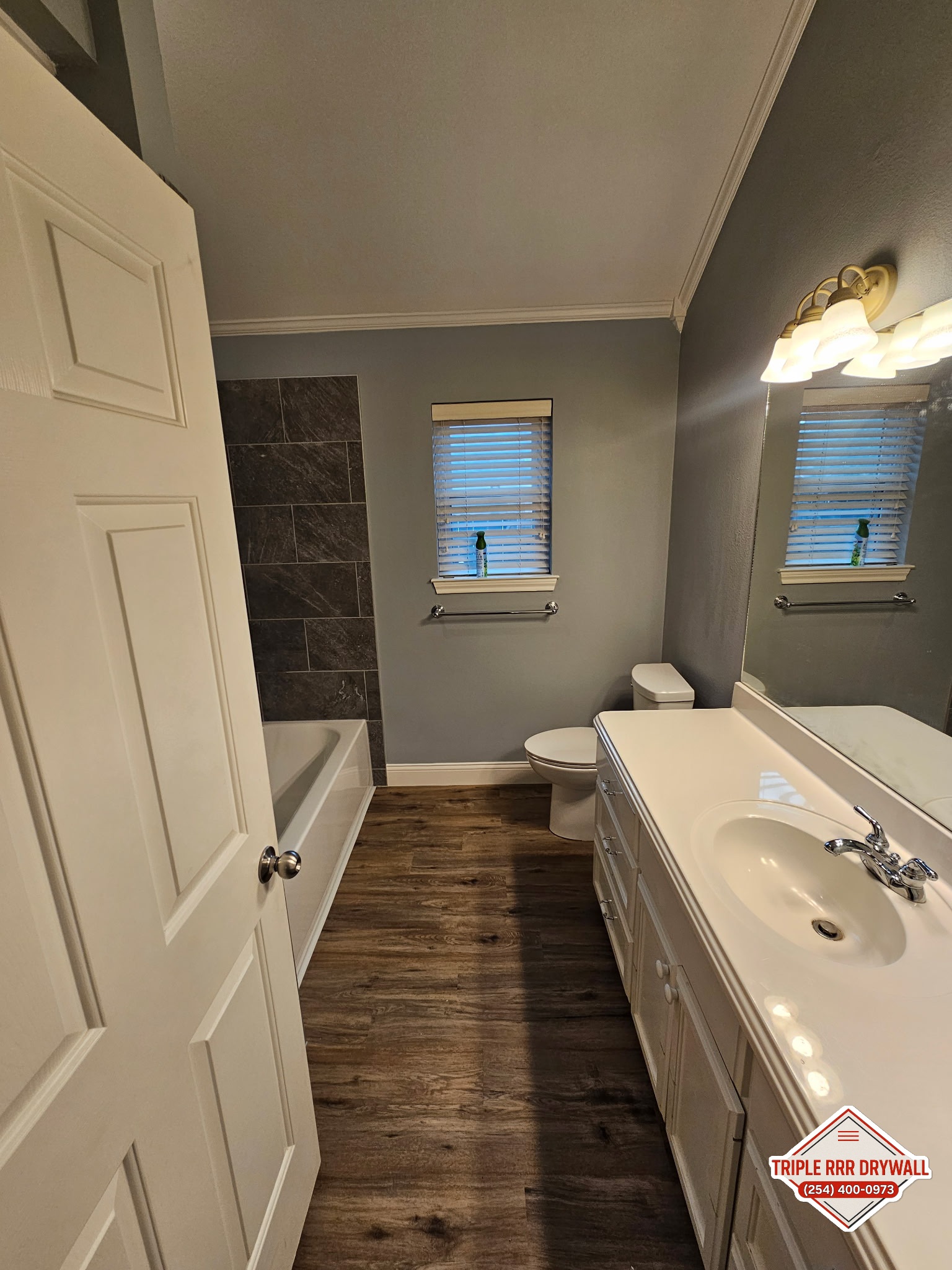 Finished bathroom flooring painting and cabinet area after water damage repair in Waco